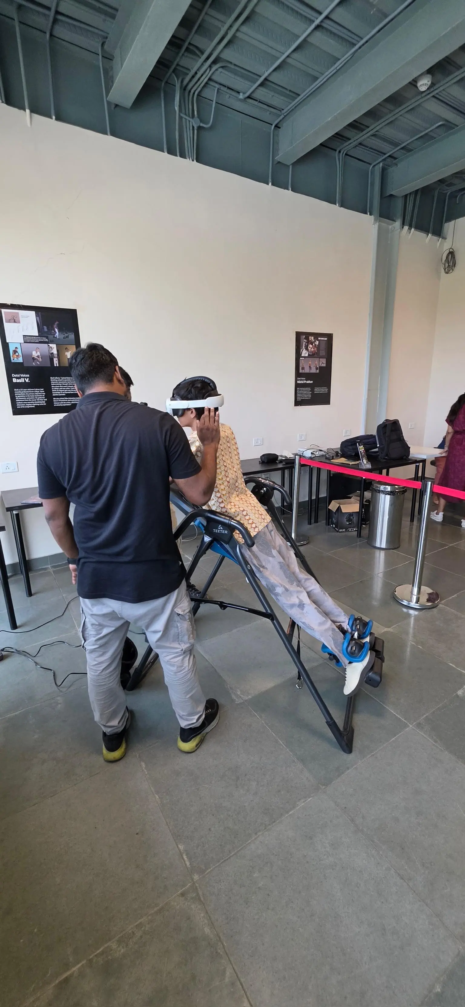 Operator assisting a SkyDrop VR Bungee guest during a real event demo